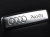 Эмблема Audi для ковриков салона - 1 шт., 18х64 мм